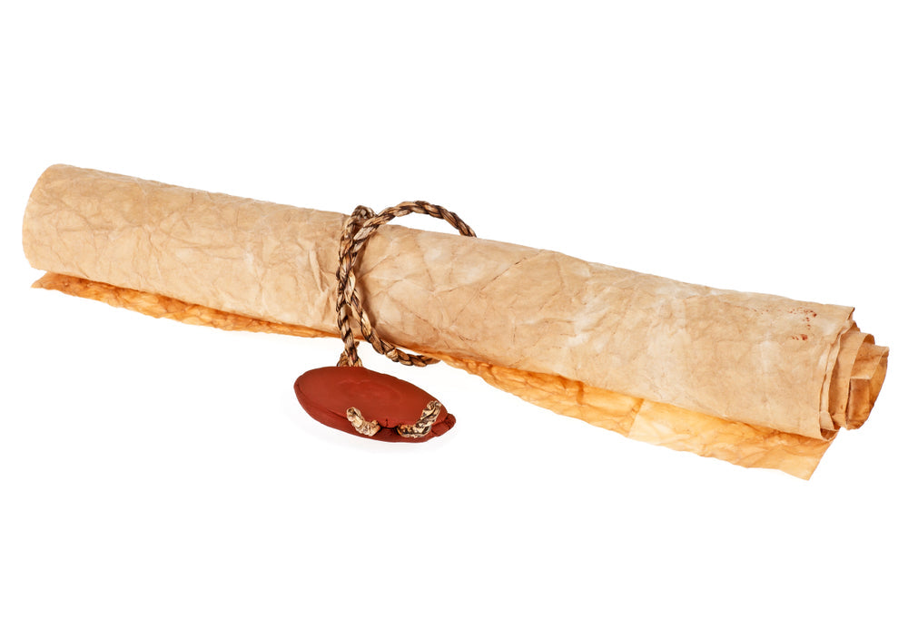 An aged parchment scroll tied with braided cord and sealed with red wax against a white background.