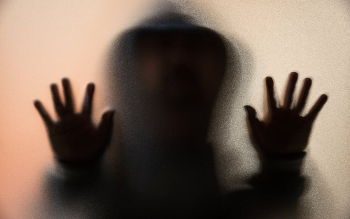 Silhouette of a Lost Soul with hands raised against a light background.